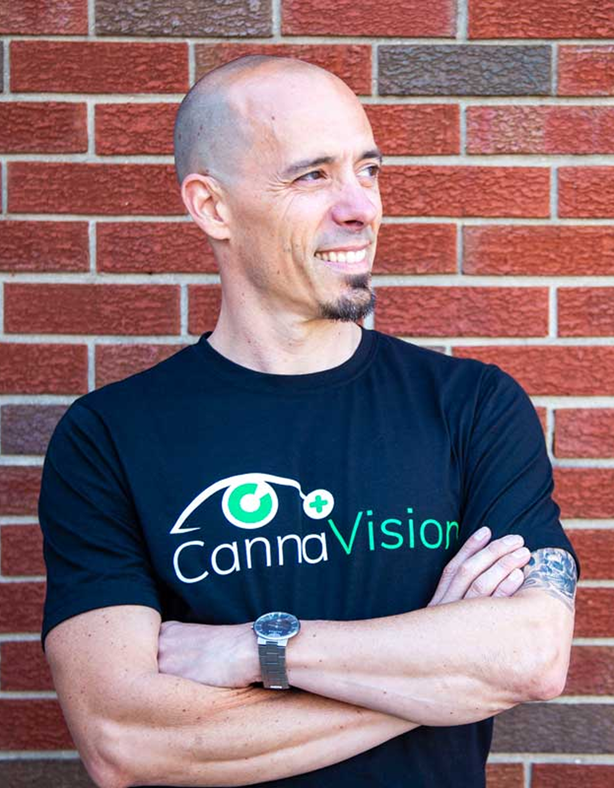 Portrait of Dr. Andy Rosenfarb standing in front of a brick wall
