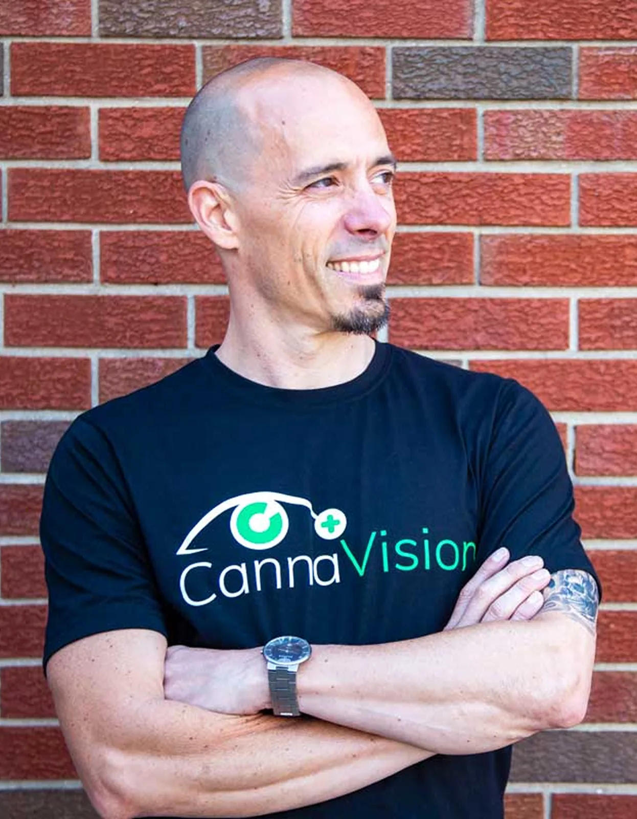 Portrait of Dr. Andy Rosenfarb standing in front of a brick wall